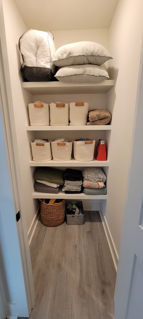 Built-in linen closet floating shelves, painted white, local to Charlotte, NC