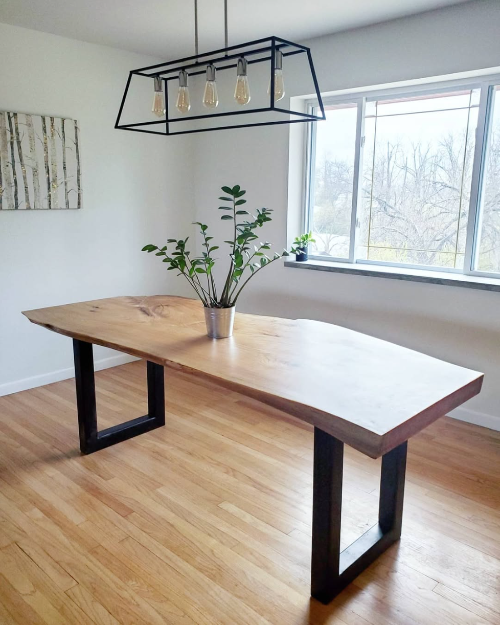 Single slab oak live edge dining table with metal legs.